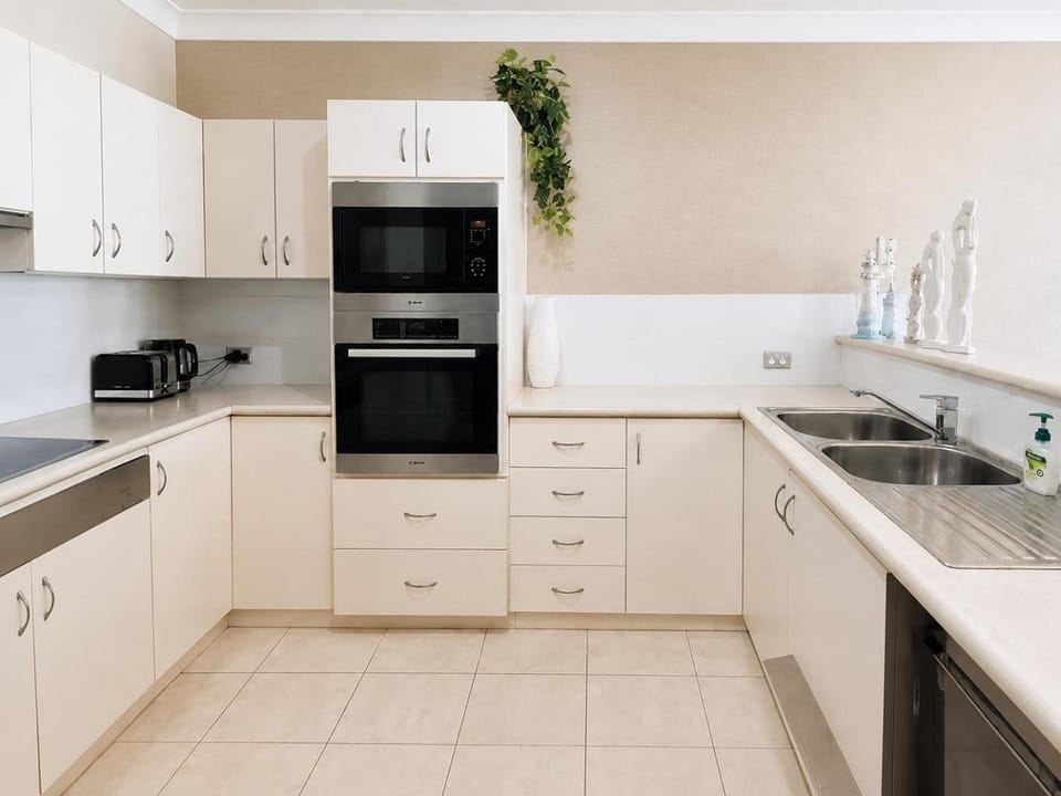 Kitchen or kitchenette, dishwasher, oven, stove