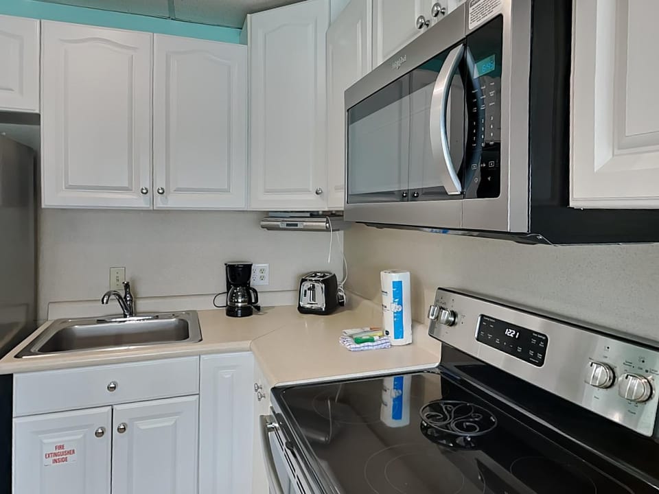 Kitchen or kitchenette, microwave, stove, toaster, kitchen