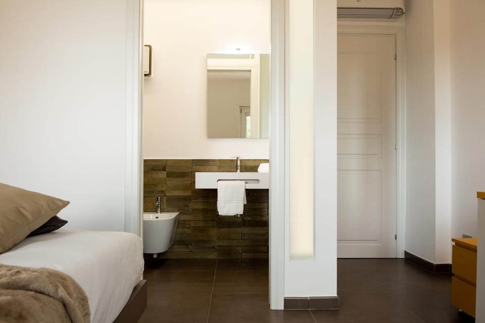 Bathroom, bidet, towels, air conditioner
