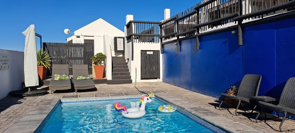 Property building, Patio, Day, Natural landscape, View (from property/room), Balcony/Terrace, Pool view, Swimming pool, Swimming pool, sunbed, towels