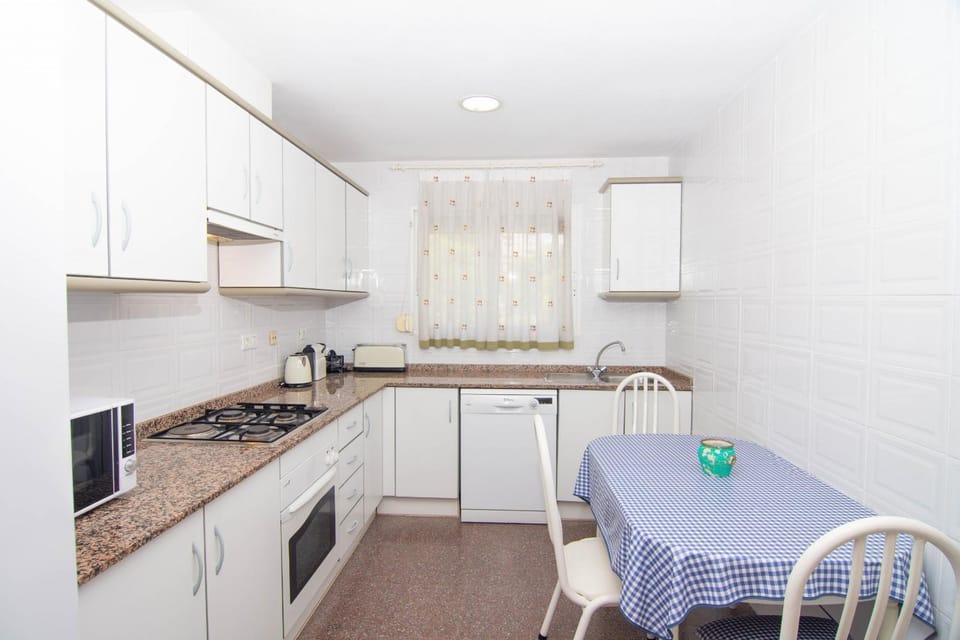 Kitchen or kitchenette, dishwasher, oven, stove