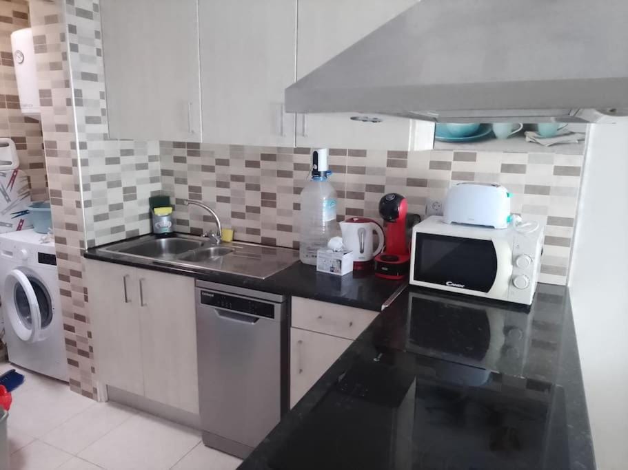 Kitchen or kitchenette, dishwasher, oven, stove, toaster, washing machine
