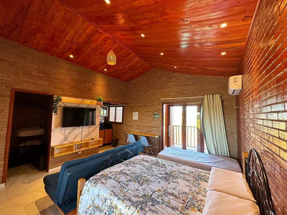 Bed, TV and multimedia, Living room, Seating area, Bedroom