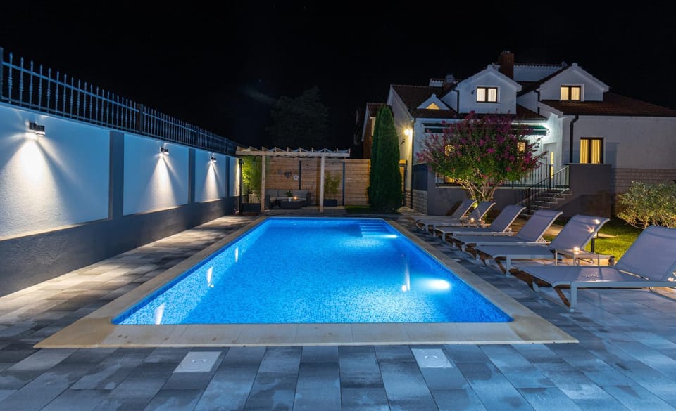 Property building, Patio, Night, Pool view, Swimming pool, sunbed