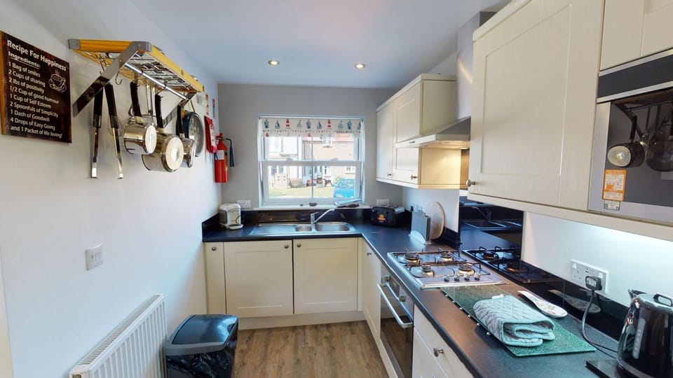 Kitchen or kitchenette, dishwasher, oven, stove, toaster