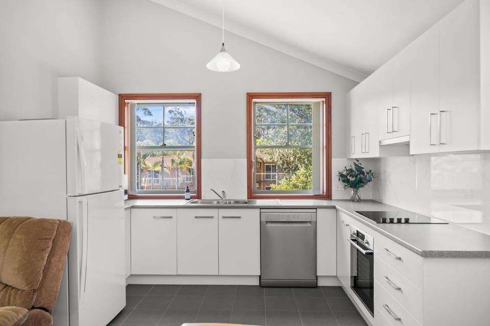 Kitchen or kitchenette, dishwasher, oven, stove