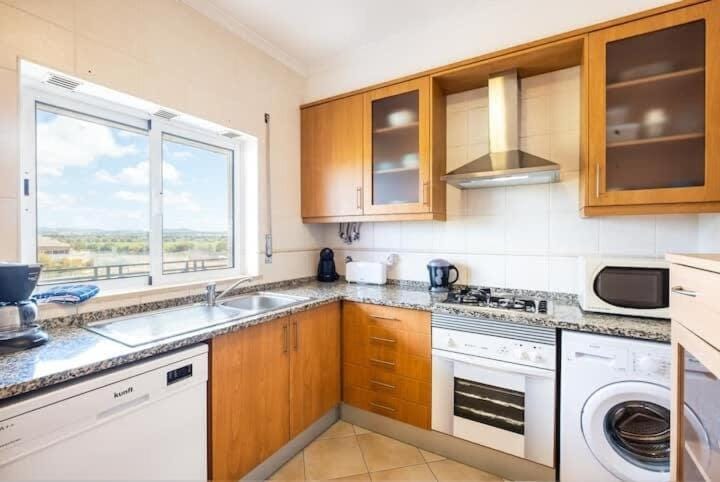 Kitchen or kitchenette, dishwasher, oven, stove, toaster, washing machine