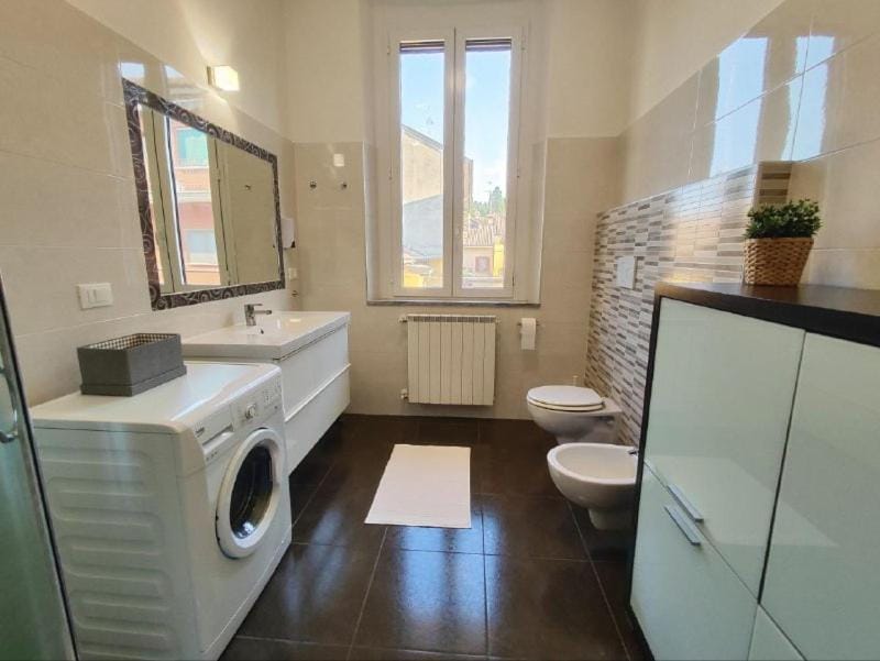 Toilet, Bathroom, bidet, towels, washing machine