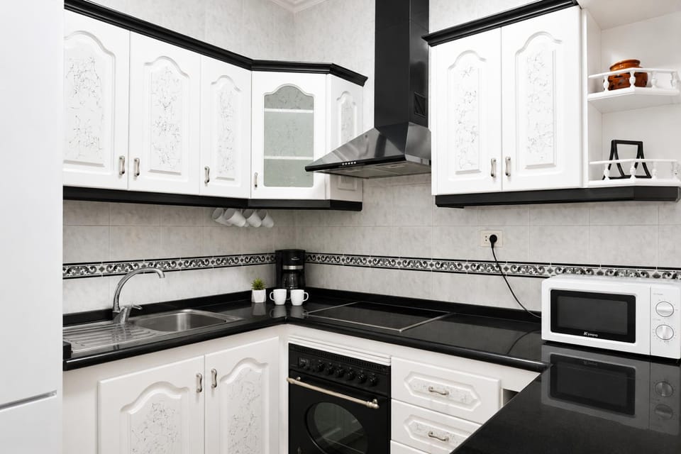 Kitchen or kitchenette, microwave, oven, stove