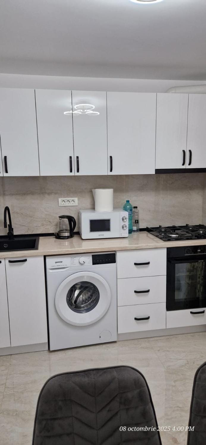 Kitchen or kitchenette, flat iron, microwave, stove, washing machine, dryer