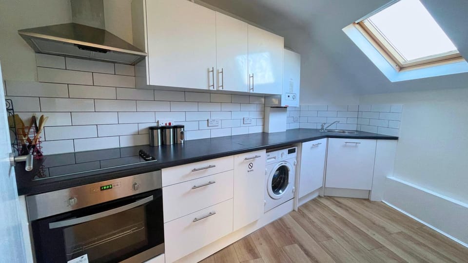 Kitchen or kitchenette, dishwasher, oven, stove, washing machine