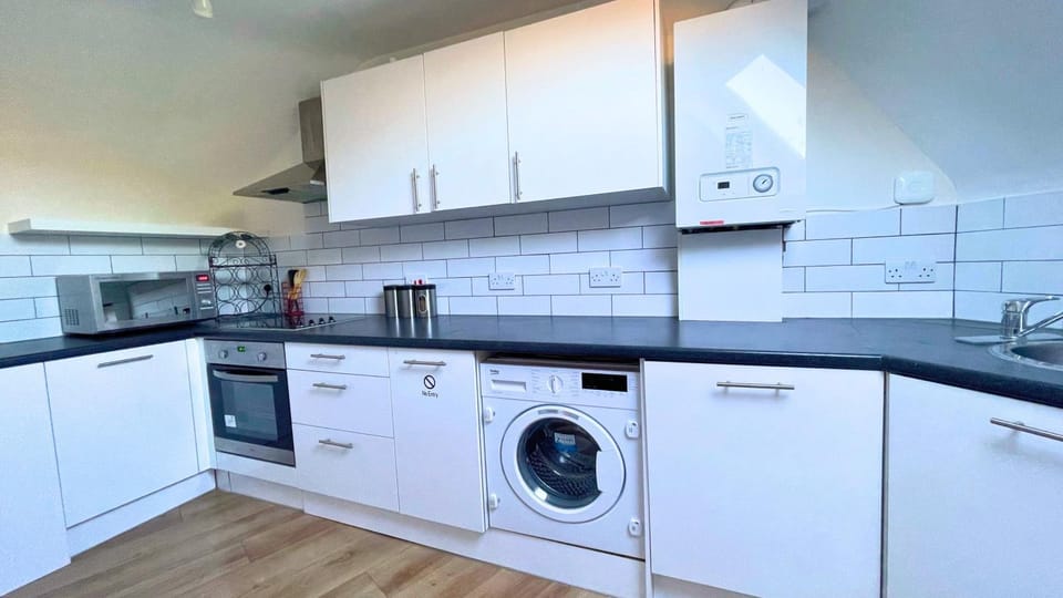 Kitchen or kitchenette, dishwasher, oven, stove, washing machine