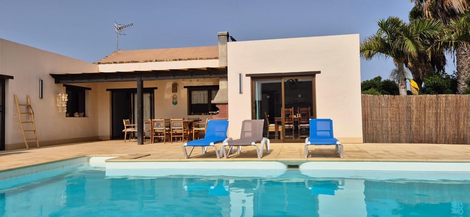 Property building, Patio, Seating area, Pool view, Swimming pool, sunbed