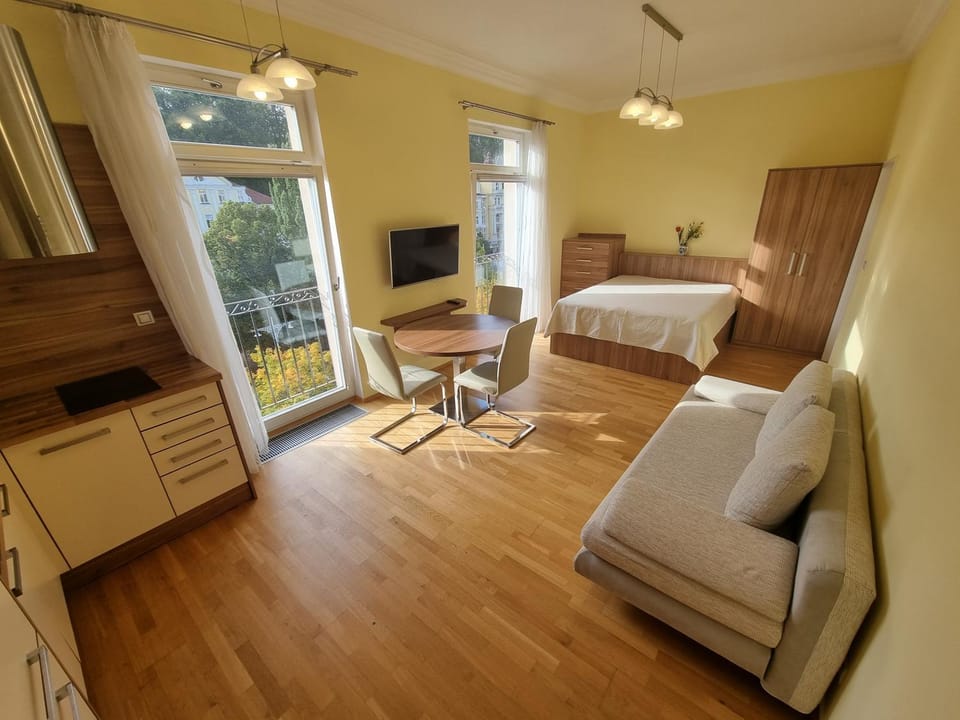 Bed, TV and multimedia, Living room, Seating area, hair dresser