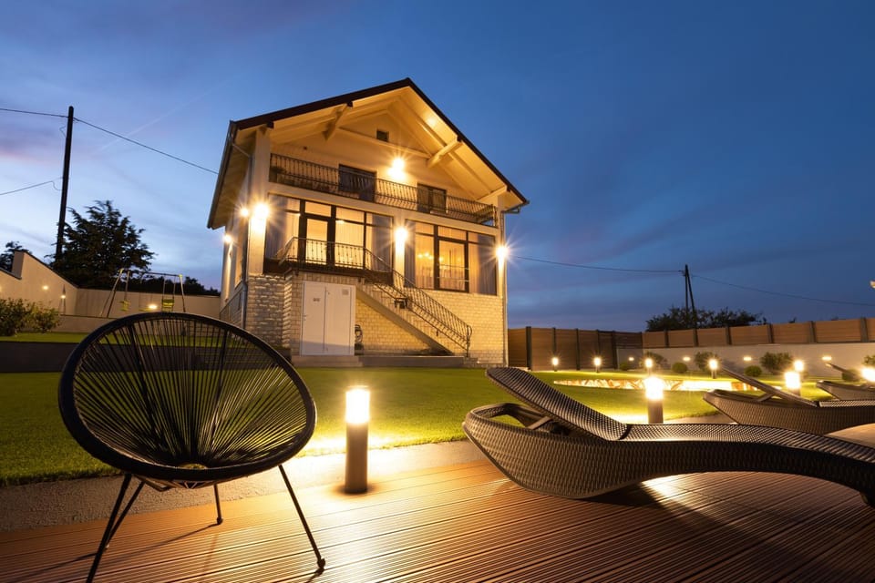 Property building, Patio, Night, Seating area, Pool view, Swimming pool, sunbed