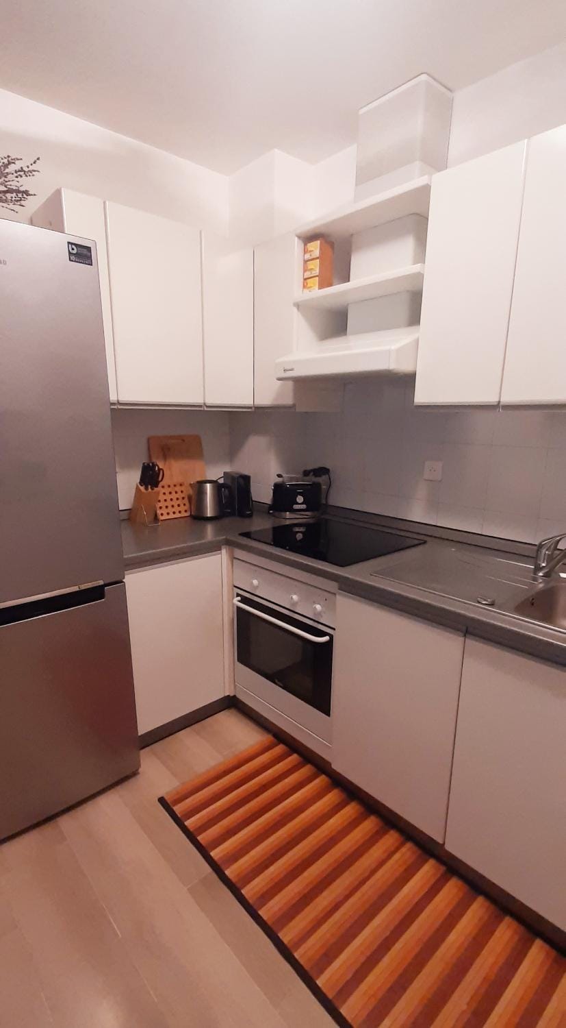 Kitchen or kitchenette, dishwasher, oven, stove