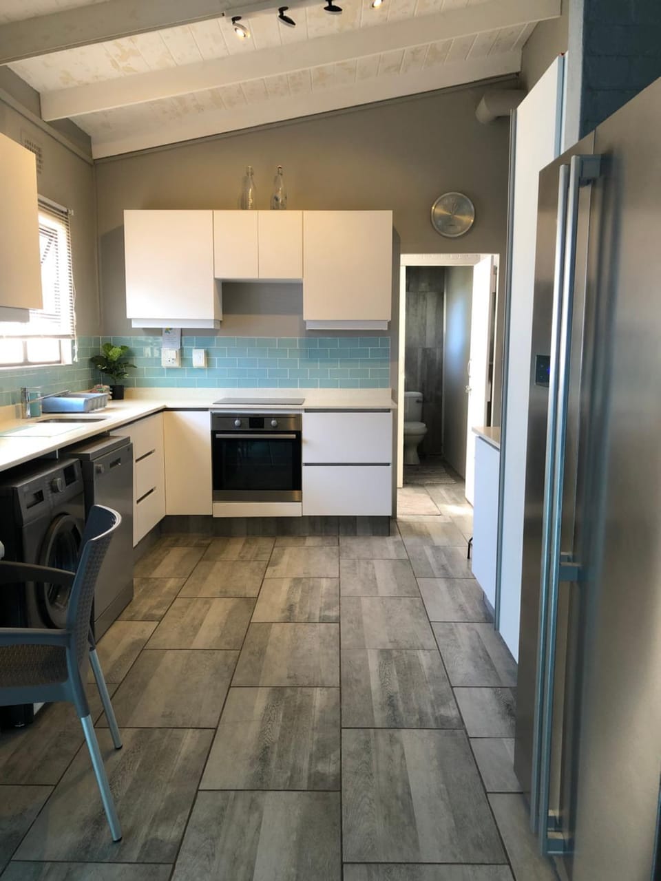 Kitchen or kitchenette, dishwasher, oven, stove, washing machine