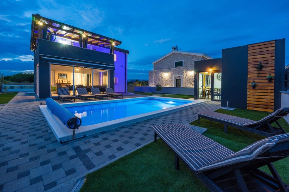 Property building, Patio, Night, Pool view, Swimming pool, sunbed