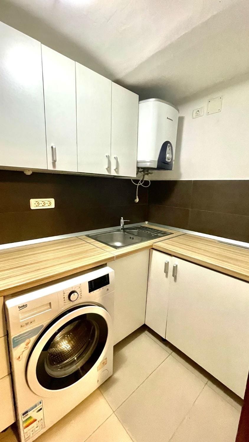Kitchen or kitchenette, washing machine
