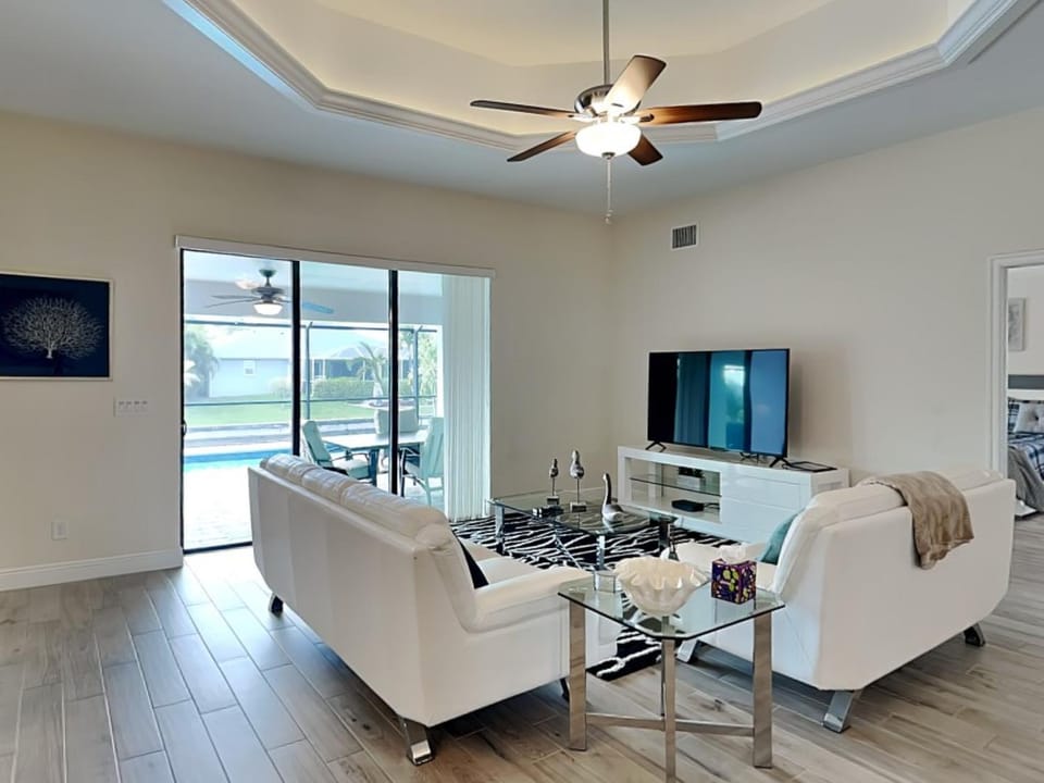 TV and multimedia, Living room, Seating area, Pool view, Swimming pool, furniture, air conditioner