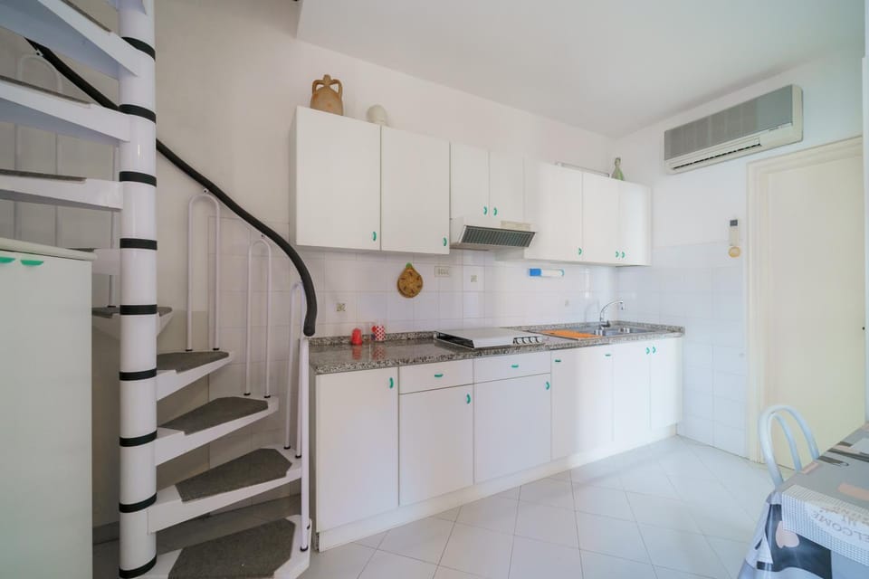 Kitchen or kitchenette, stove, air conditioner