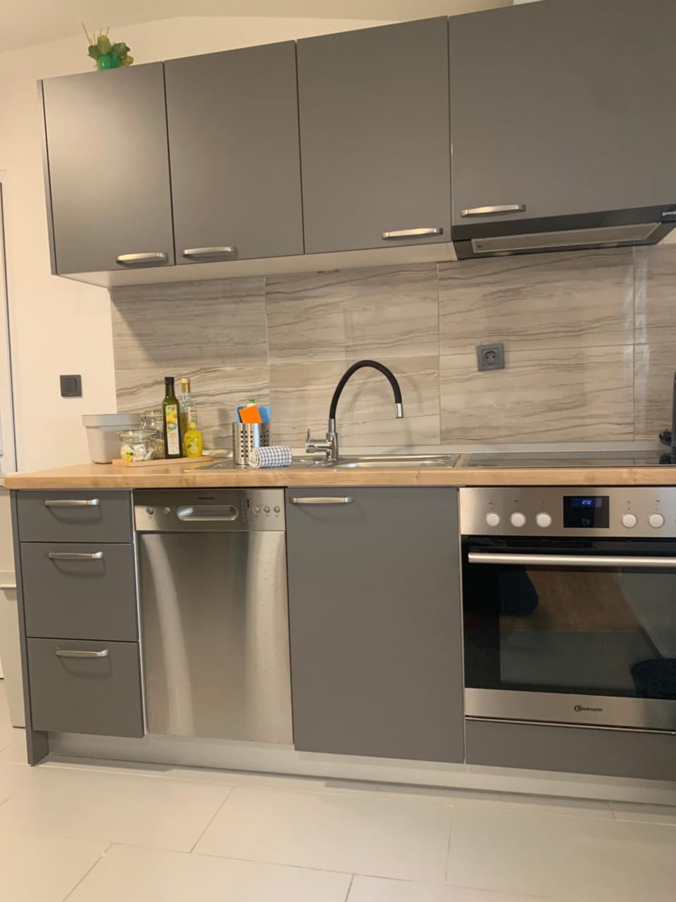 Kitchen or kitchenette, dishwasher, oven, stove