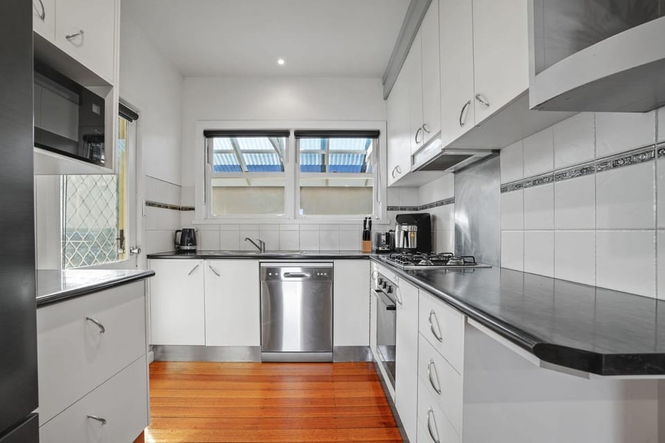 Kitchen or kitchenette, dishwasher, oven, stove