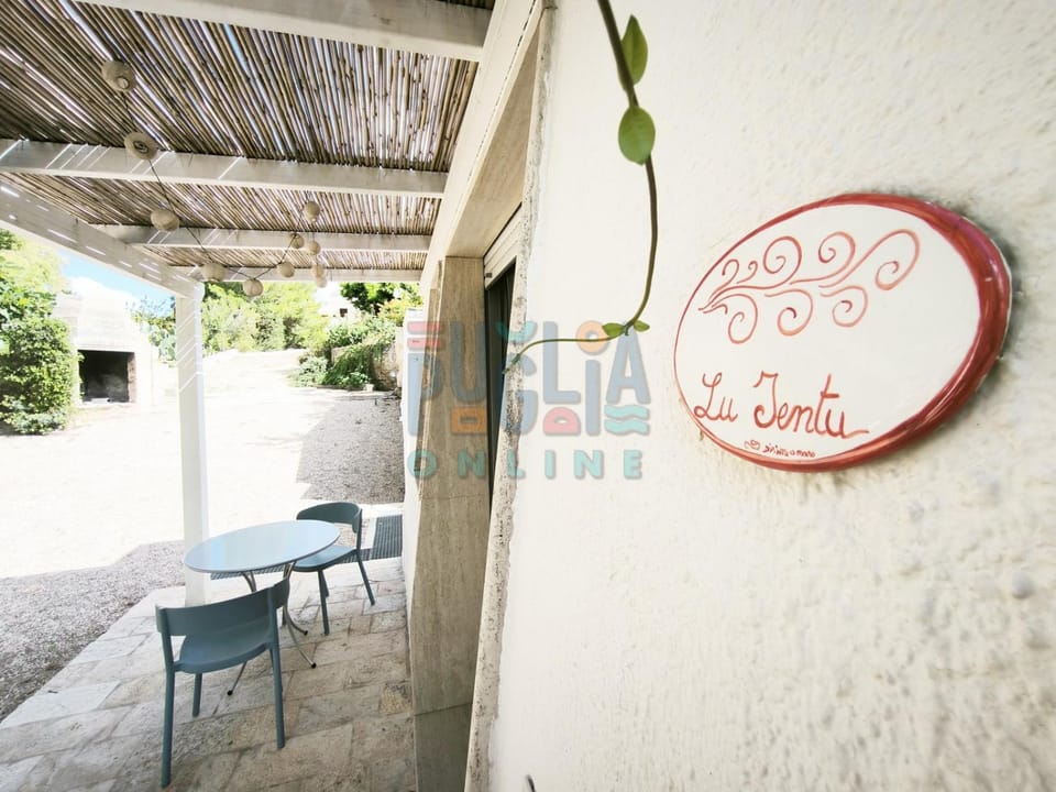 Patio, Day, Property logo or sign, Dining area, Logo/Certificate/Sign, Text overlay, Certificate/Award