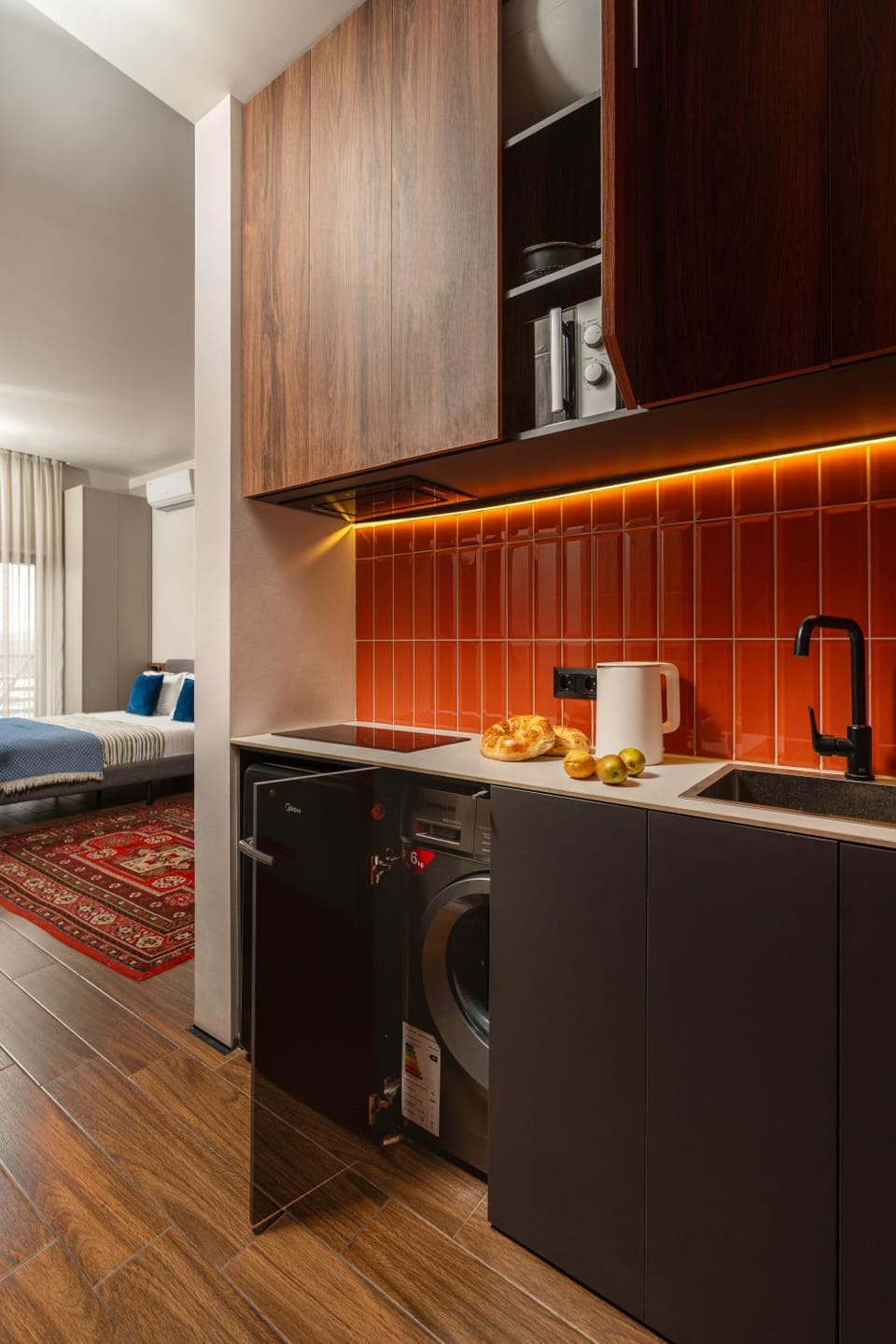 Kitchen or kitchenette, microwave, stove, washing machine
