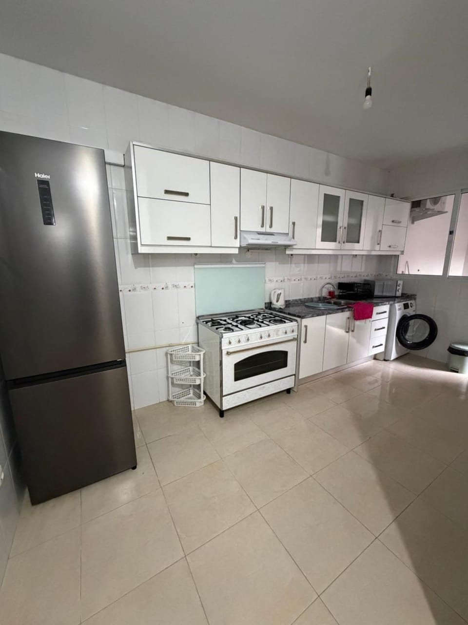 Kitchen or kitchenette, oven, stove, washing machine