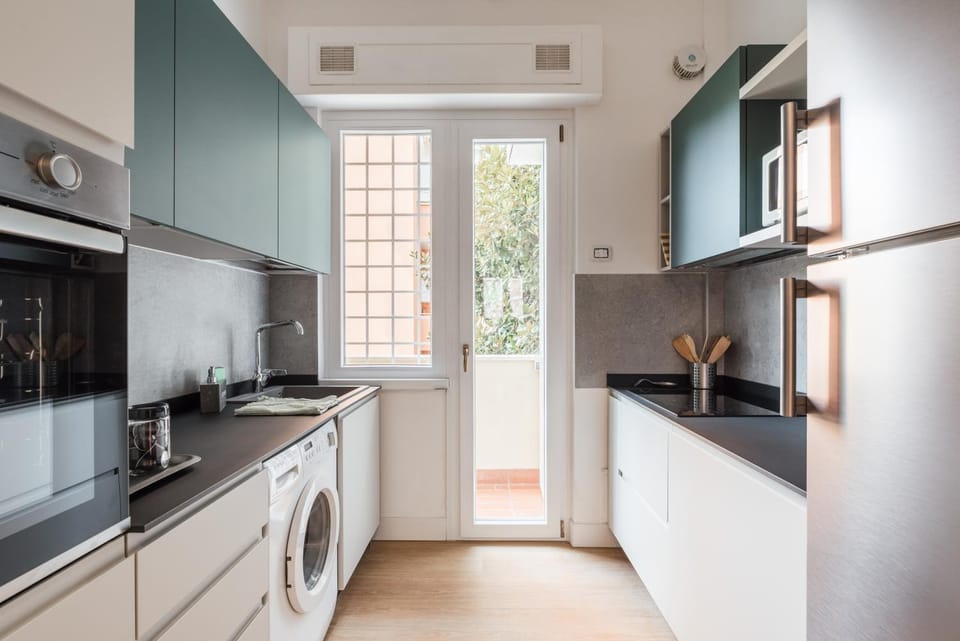 Kitchen or kitchenette, cot, flat iron, oven, stove, laundry, washing machine, kitchen