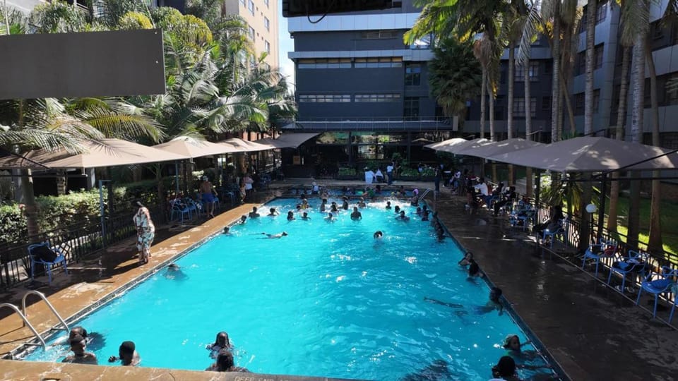 Property building, People, Swimming pool, group of guests, sunbed