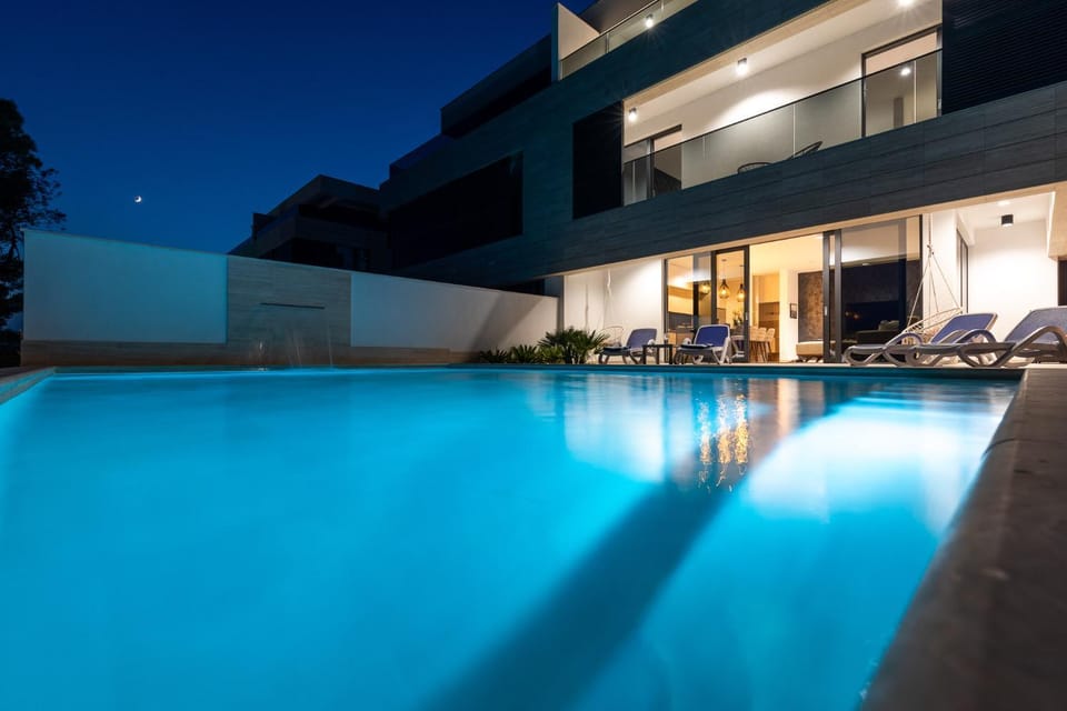 Property building, Patio, Night, Pool view, Swimming pool, sunbed