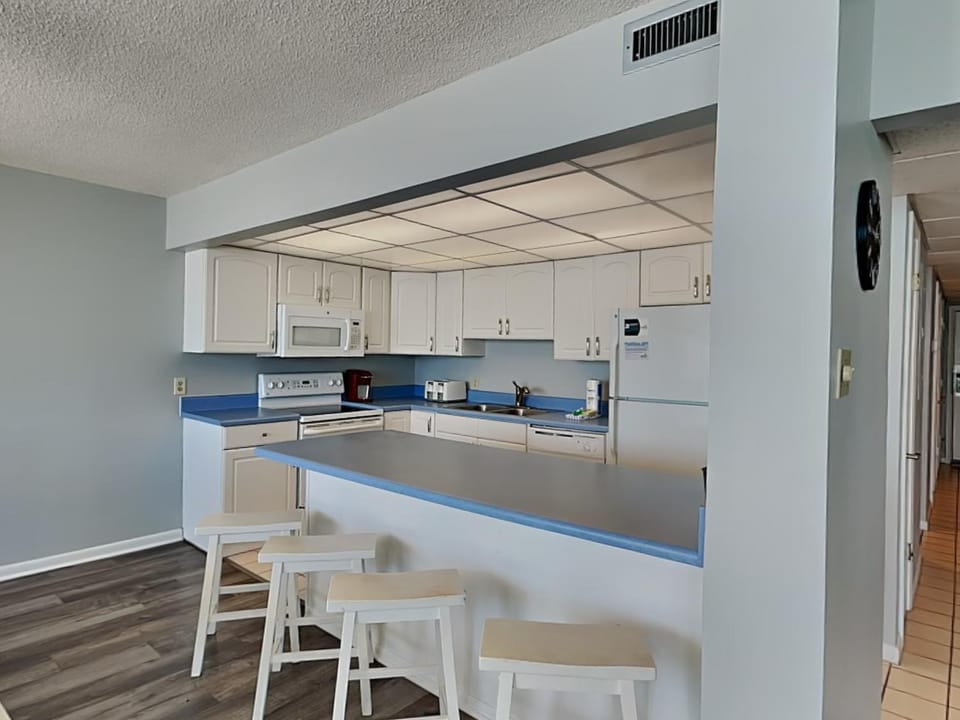 Kitchen or kitchenette, microwave, oven, stove, toaster, kitchen, air conditioner