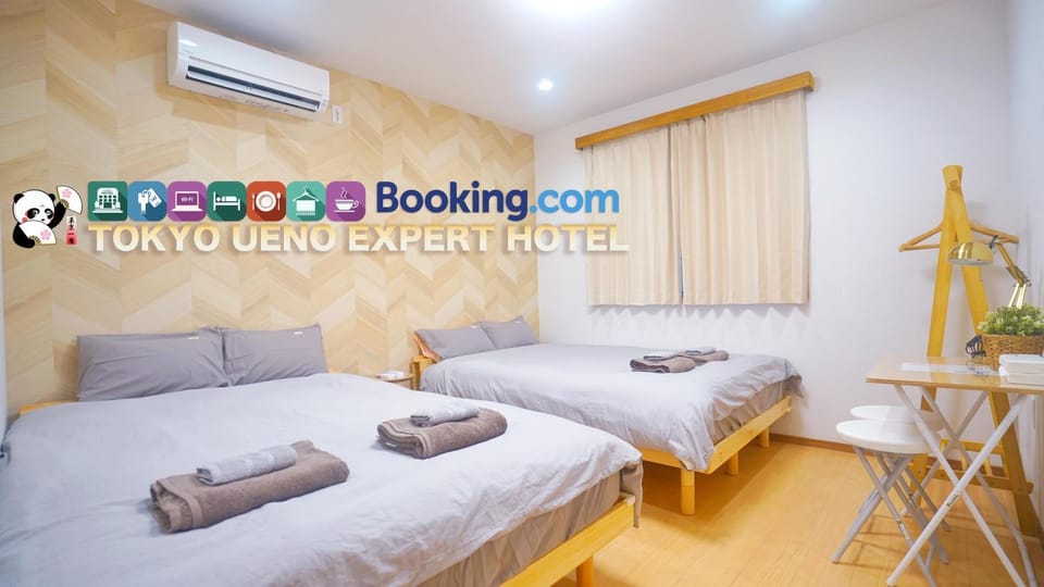 Bed, Property logo or sign, Photo of the whole room, Logo/Certificate/Sign, Bedroom, Text overlay, Certificate/Award, towels, air conditioner