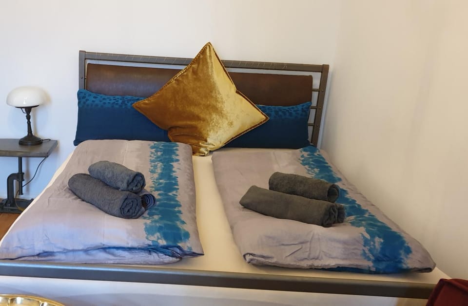 Bed, Photo of the whole room, Bedroom, Text overlay, towels