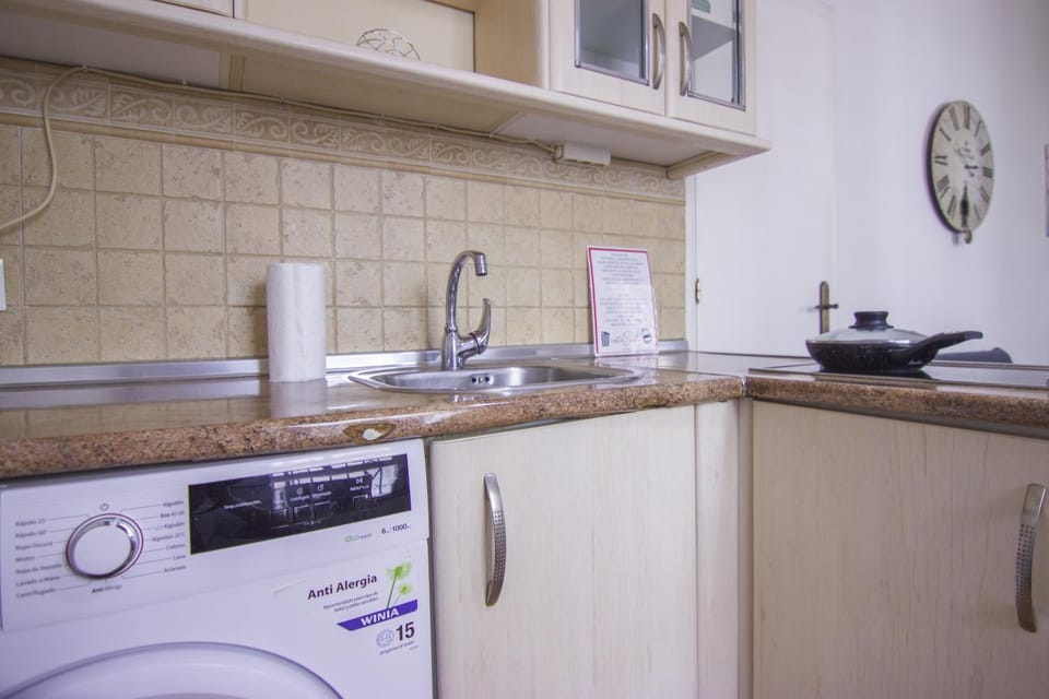 Kitchen or kitchenette, stove, washing machine