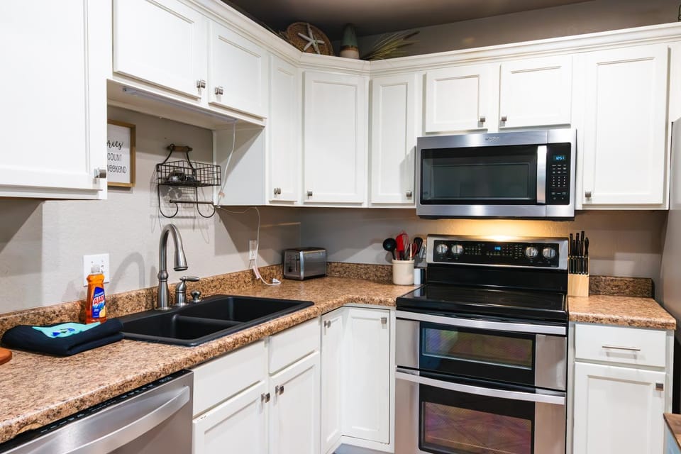 Kitchen or kitchenette, dishwasher, oven, stove, toaster