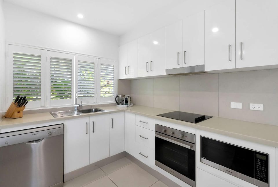 Kitchen or kitchenette, dishwasher, oven, stove
