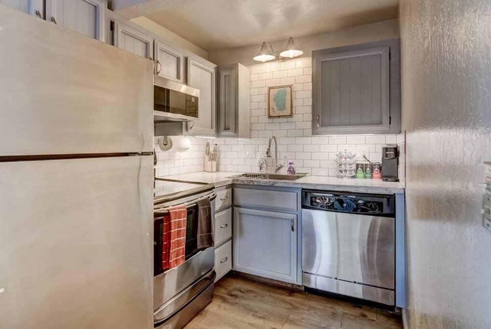 Kitchen or kitchenette, dishwasher, oven, stove
