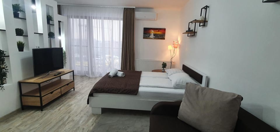 Bed, TV and multimedia, Living room, Seating area, Bedroom