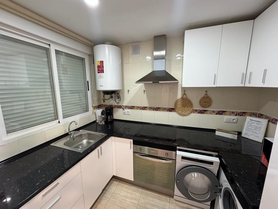 Kitchen or kitchenette, dishwasher, stove, toaster, washing machine