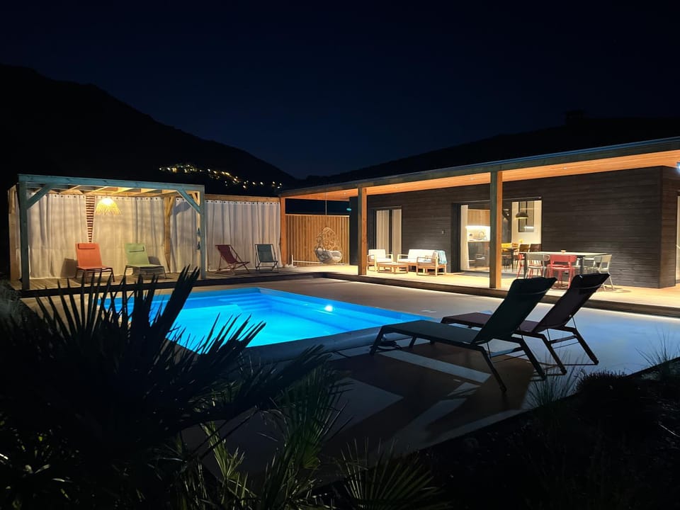 Property building, Patio, Night, Natural landscape, Pool view, Swimming pool, sunbed