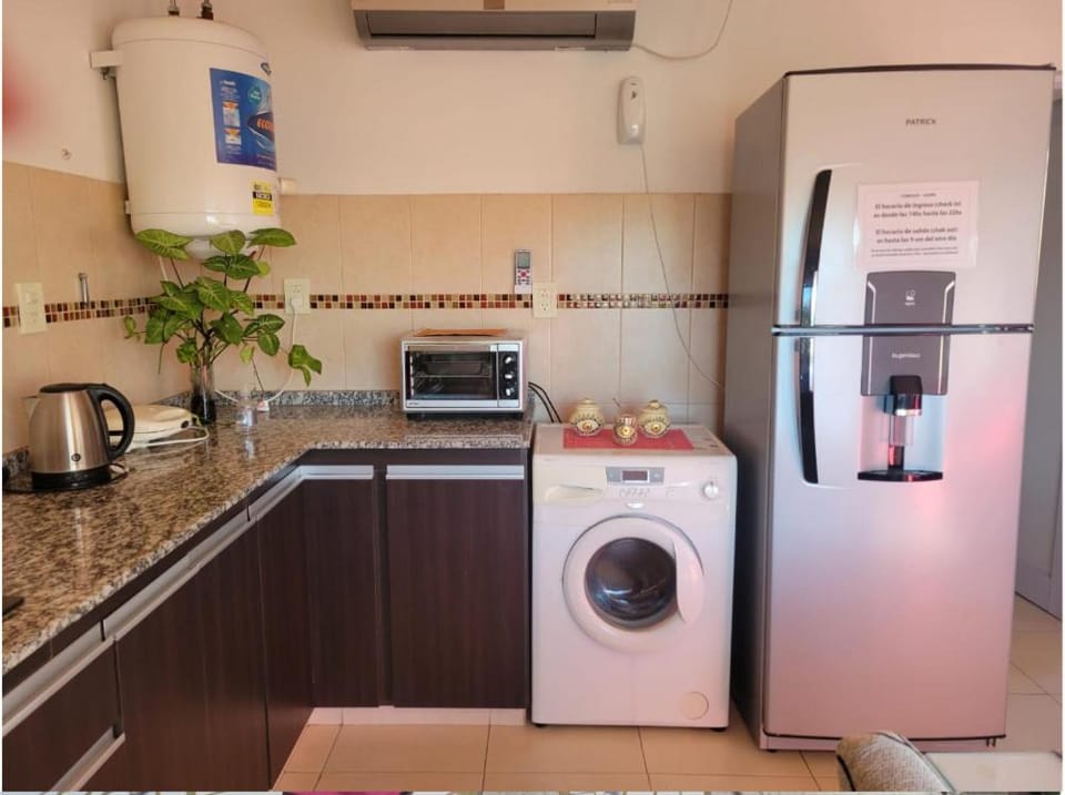 Kitchen or kitchenette, oven, toaster, washing machine