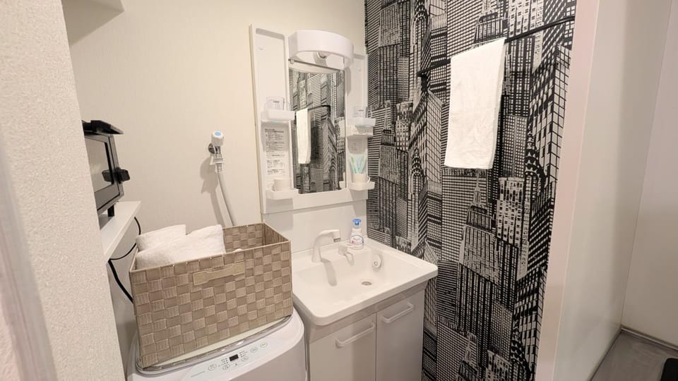 Bathroom, toaster, towels, washing machine