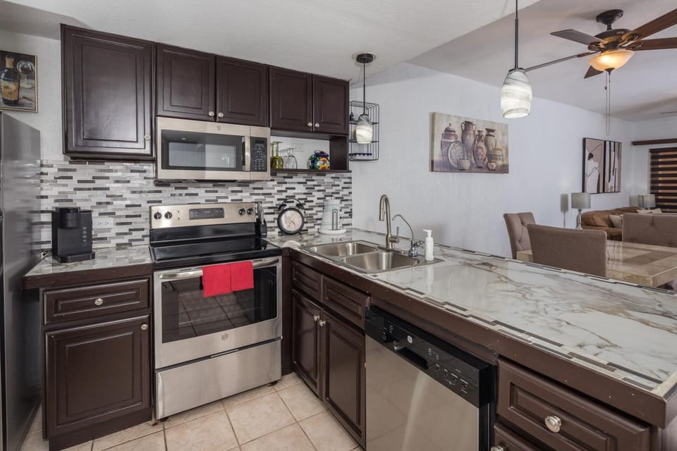 Kitchen or kitchenette, dishwasher, oven, stove