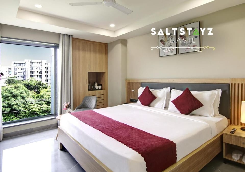 Bed, Property logo or sign, Coffee/tea facilities, Photo of the whole room, Bedroom, Text overlay, wardrobe