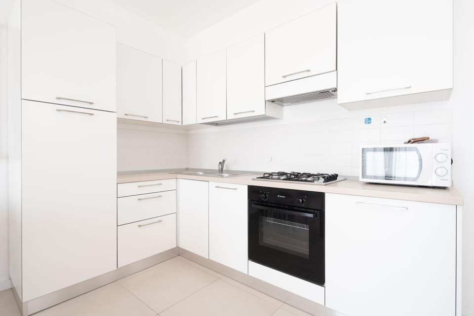 Kitchen or kitchenette, dishwasher, oven, stove