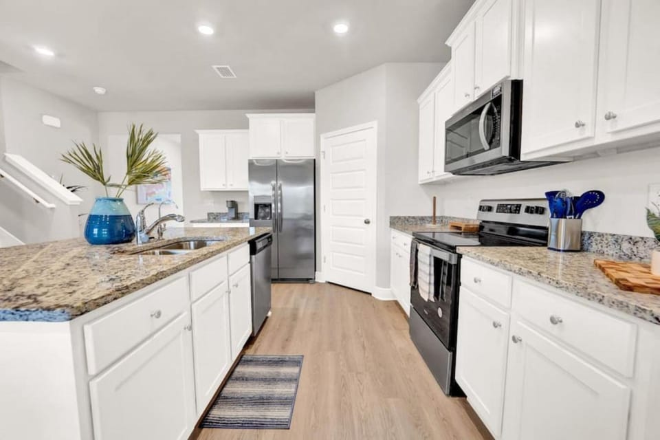 Kitchen or kitchenette, dishwasher, oven, stove