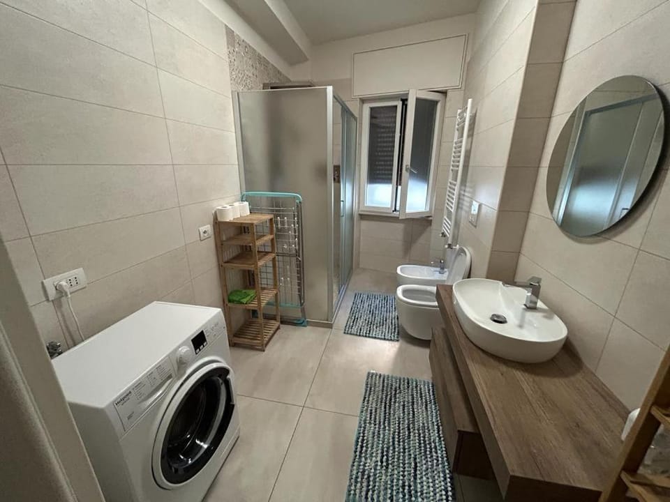 Shower, Toilet, Bathroom, Bath, bidet, towels, washing machine, dryer